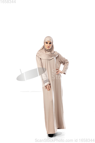 Image of Beautiful arab woman posing in stylish hijab isolated on studio background. Fashion concept