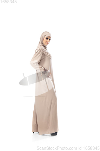 Image of Beautiful arab woman posing in stylish hijab isolated on studio background. Fashion concept