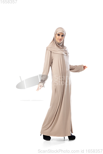 Image of Beautiful arab woman posing in stylish hijab isolated on studio background. Fashion concept
