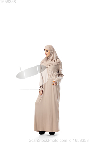 Image of Beautiful arab woman posing in stylish hijab isolated on studio background. Fashion concept