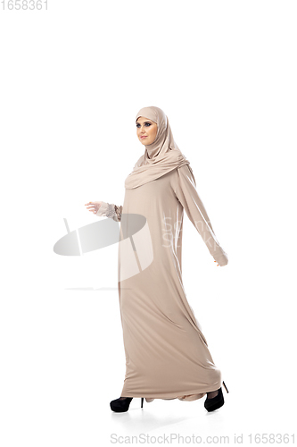 Image of Beautiful arab woman posing in stylish hijab isolated on studio background. Fashion concept