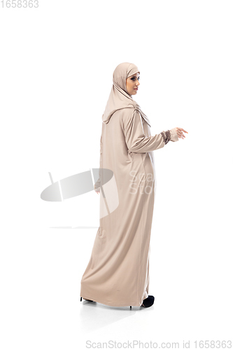 Image of Beautiful arab woman posing in stylish hijab isolated on studio background. Fashion concept