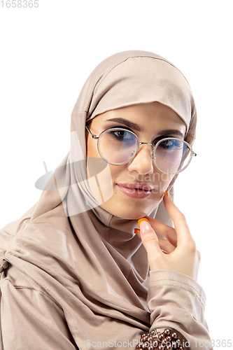 Image of Beautiful arab woman posing in stylish hijab isolated on studio background. Fashion concept