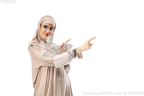 Image of Beautiful arab woman posing in stylish hijab isolated on studio background. Fashion concept