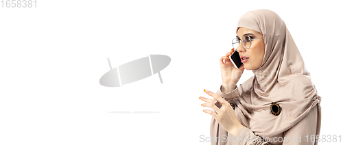 Image of Beautiful arab woman posing in stylish hijab isolated on studio background. Fashion concept