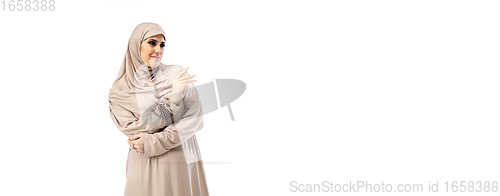 Image of Beautiful arab woman posing in stylish hijab isolated on studio background. Fashion concept