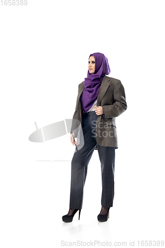 Image of Beautiful arab woman posing in stylish office attire isolated on studio background. Fashion concept