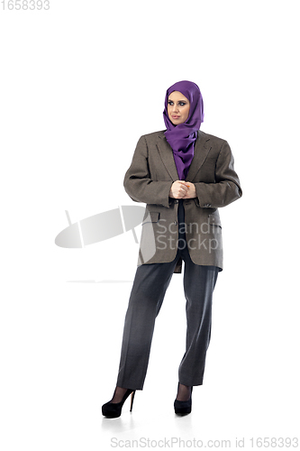 Image of Beautiful arab woman posing in stylish office attire isolated on studio background. Fashion concept