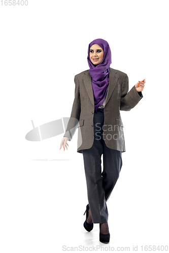 Image of Beautiful arab woman posing in stylish office attire isolated on studio background. Fashion concept