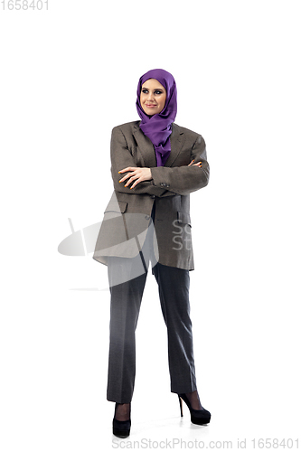 Image of Beautiful arab woman posing in stylish office attire isolated on studio background. Fashion concept