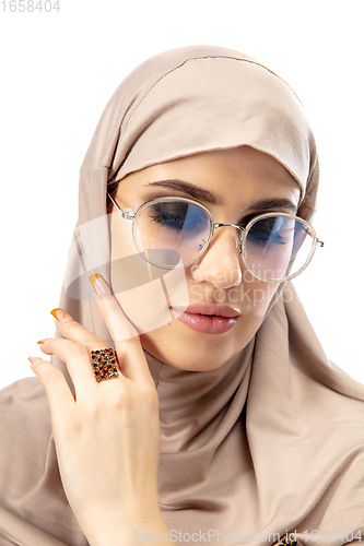 Image of Beautiful arab woman posing in stylish hijab isolated on studio background. Fashion concept