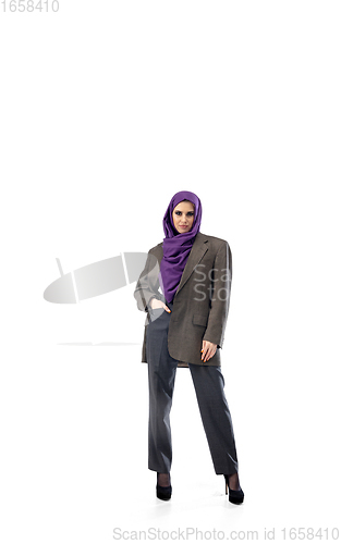 Image of Beautiful arab woman posing in stylish office attire isolated on studio background. Fashion concept