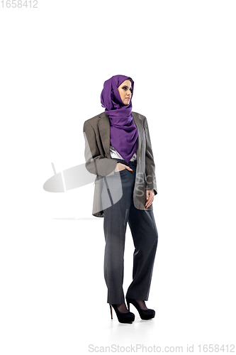 Image of Beautiful arab woman posing in stylish office attire isolated on studio background. Fashion concept