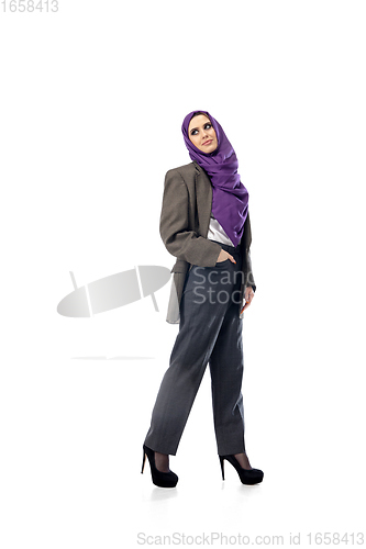 Image of Beautiful arab woman posing in stylish office attire isolated on studio background. Fashion concept