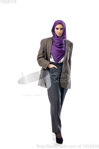 Image of Beautiful arab woman posing in stylish office attire isolated on studio background. Fashion concept