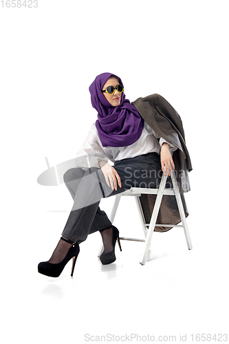 Image of Beautiful arab woman posing in stylish office attire isolated on studio background. Fashion concept