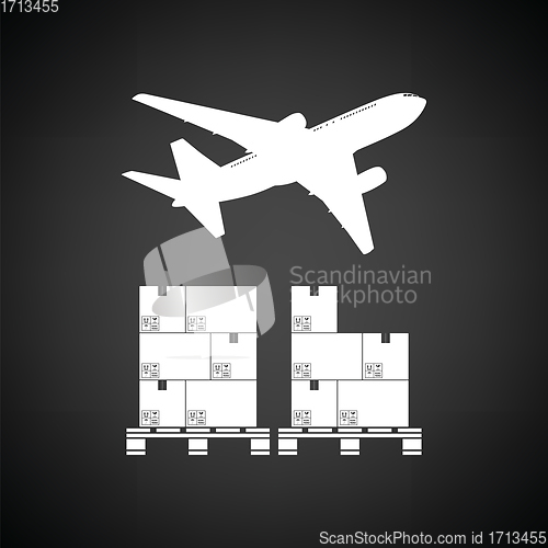 Image of Boxes on pallet under airplane