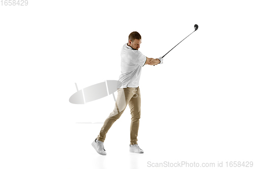 Image of Golf player in a white shirt taking a swing isolated on white studio background