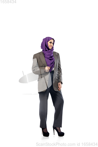 Image of Beautiful arab woman posing in stylish office attire isolated on studio background. Fashion concept