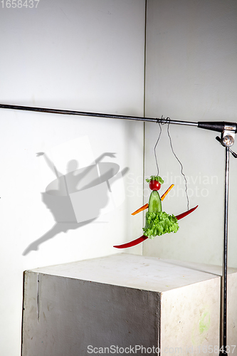 Image of Flying food composition making beautiful ballerina drawing shadow on the wall