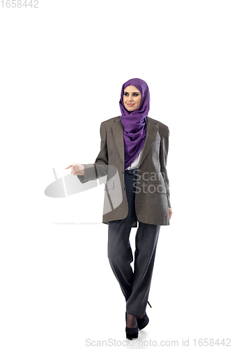 Image of Beautiful arab woman posing in stylish office attire isolated on studio background. Fashion concept