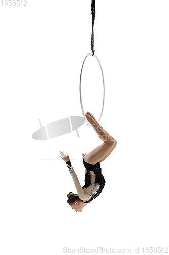 Image of Young female acrobat, circus athlete isolated on white studio background. Training perfect balanced in flight