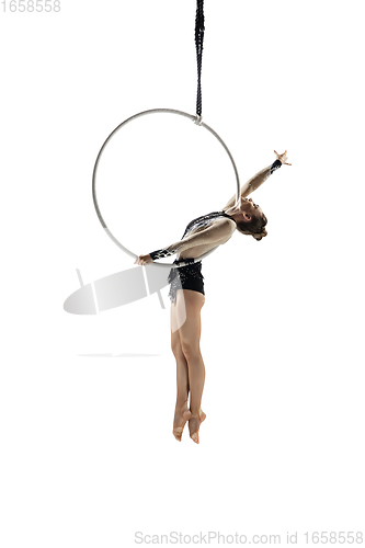 Image of Young female acrobat, circus athlete isolated on white studio background. Training perfect balanced in flight