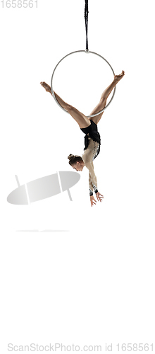 Image of Young female acrobat, circus athlete isolated on white studio background. Training perfect balanced in flight