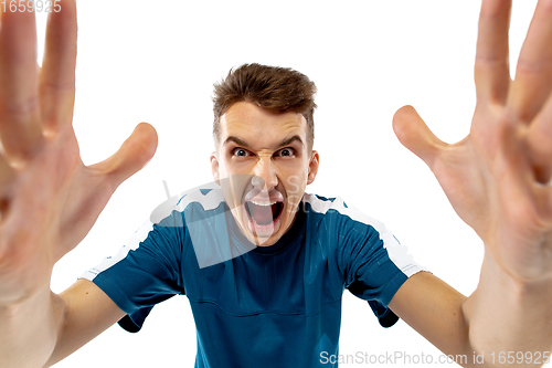 Image of Funny emotions of professional soccer player isolated on white studio background, excitement in game