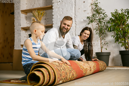 Image of Young family doing apartment repair together themselves. Mother, father and son doing home makeover or renovation
