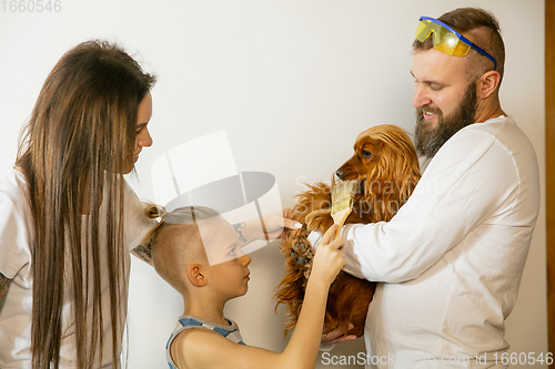 Image of Young family doing apartment repair together themselves. Mother, father and son doing home makeover or renovation