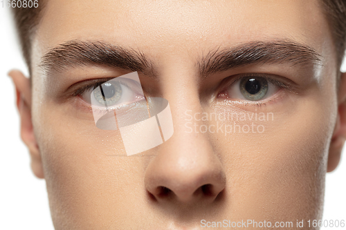 Image of Close up face of young man isolated on white studio background. Caucasian attractive male model. Concept of fashion and beauty, self-care, body and skin care.