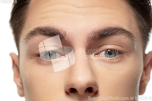 Image of Close up face of young man isolated on white studio background. Caucasian attractive male model. Concept of fashion and beauty, self-care, body and skin care.