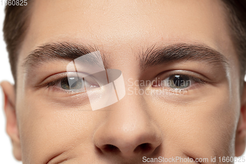 Image of Close up face of young man isolated on white studio background. Caucasian attractive male model. Concept of fashion and beauty, self-care, body and skin care.