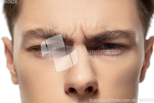 Image of Close up face of young man isolated on white studio background. Caucasian attractive male model. Concept of fashion and beauty, self-care, body and skin care.