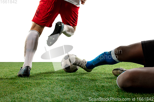 Image of Close up legs of professional soccer, football players fighting for ball on field isolated on white background