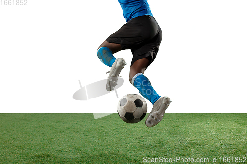 Image of Close up legs of professional soccer, football player fighting for ball on field isolated on white background