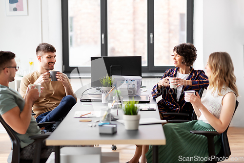 Image of team of startuppers drinking coffee at office