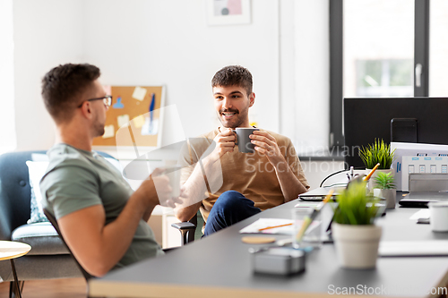 Image of men or startuppers drinking coffee at office
