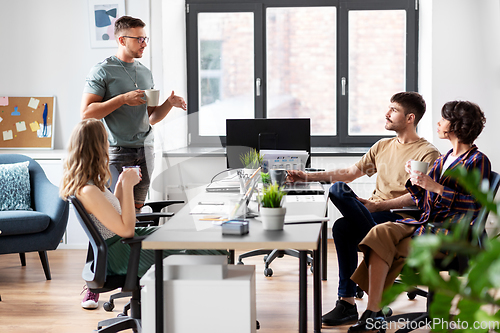 Image of team of startuppers drinking coffee at office