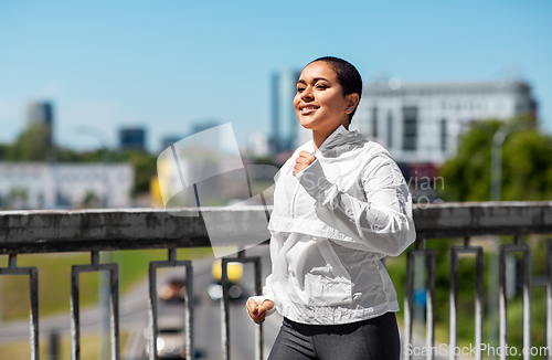 Image of african american woman running outdoors