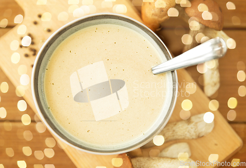 Image of mushroom cream soup in bowl on cutting board