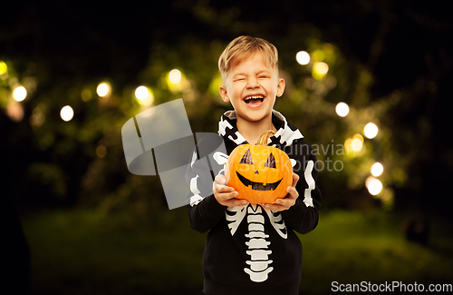 Image of happy boy in halloween costume with jack-o-lantern