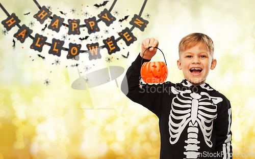 Image of happy boy in halloween costume with jack-o-lantern