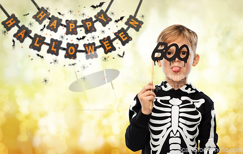 Image of boy in halloween costume of skeleton making faces