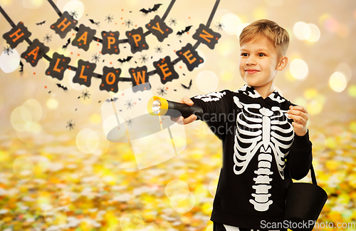 Image of happy with candies and flashlight on halloween