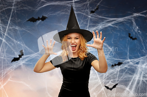 Image of scary woman in black halloween costume of witch