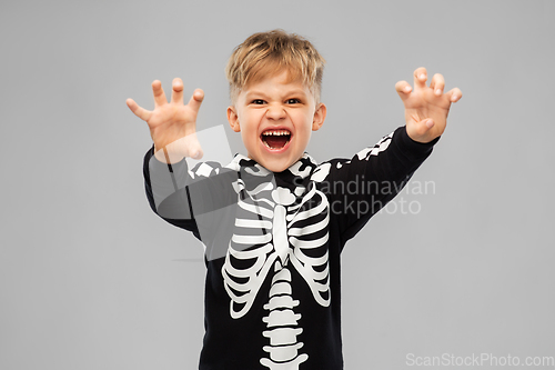 Image of boy in halloween costume of skeleton making faces