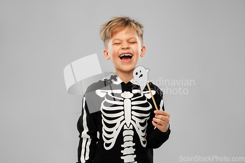 Image of boy in halloween costume with ghost decoration