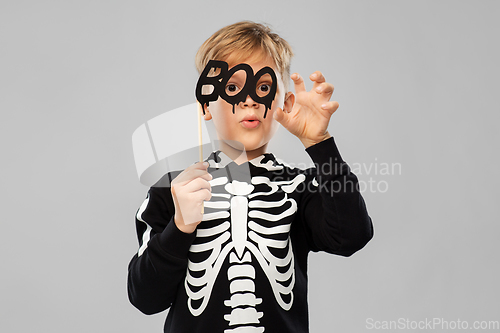 Image of boy in halloween costume of skeleton making faces